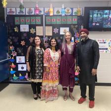 Four staff dressed in traditional attire to celebrate Diwali