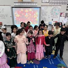 Elementary students gathered in the classroom dressed in traditional attire to celebrate Diwali