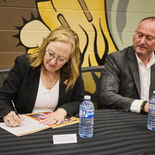 Two leaders signing the new enhancement agreement