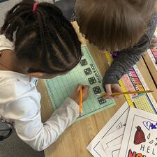 two students working together on literacy activity
