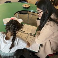 teacher and student doing literacy assessment